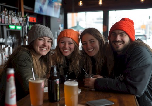 group of friends sitting at table smiling at camera