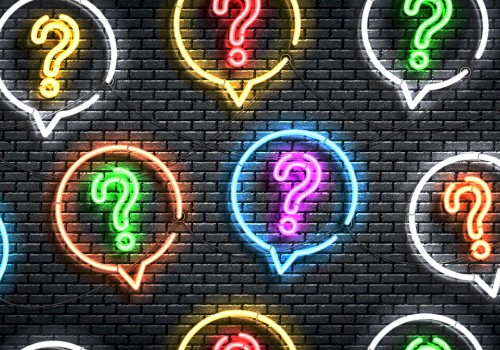 The image shows colorful neon question marks inside speech bubbles on a dark brick wall backdrop.